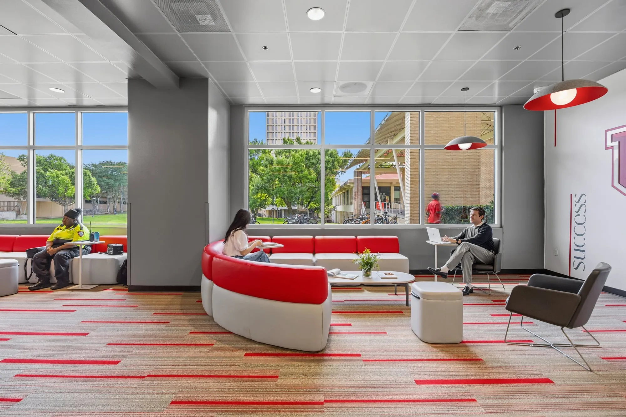 Wide common lounge with students at the University of Houston student housing